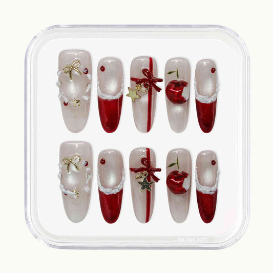 Set of Christmas-themed nail art designs in a clear plastic case.by Tennail press on nails.