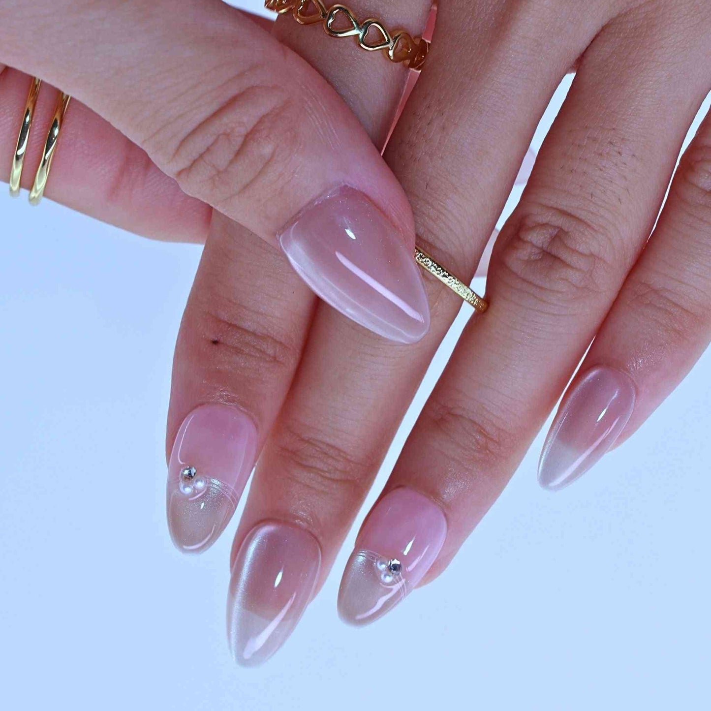Dewy French Tip Nails with soft nude hues, French tips, rhinestone details by pressonnails