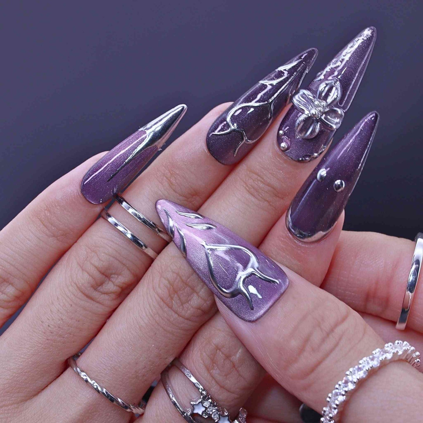 Hand with purple and silver nail art , Lavender Art press on Nails with lavender cat-eye, hand-painted florals, sleek design by Tennail