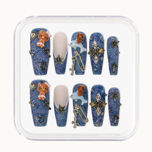 Long Coffin Tennail press-ons with denim texture, 3D kitten charms, metallic studs, and rhinestones.