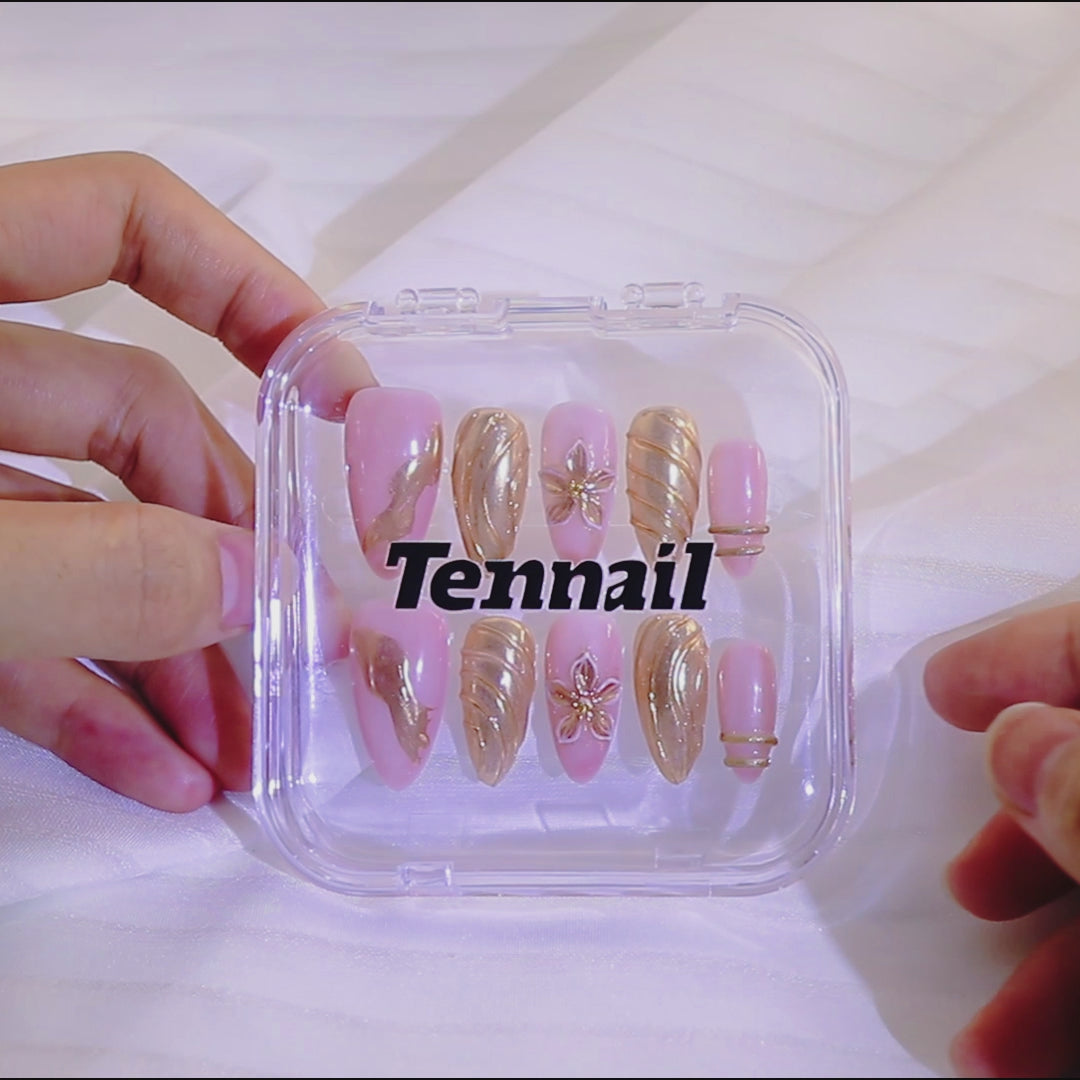 Video shows TenNail's Aphrodite Gold Floral Nails: Press - on nails with gold lines, floral accents catch the light as hands move, creating a sleek, luxurious, and elegant nail look that stands out.