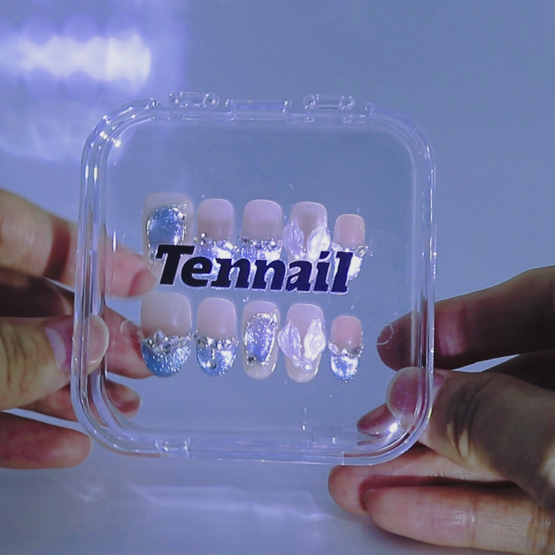 Video shows Mermaid Tides Nails: Handmade short oval press - ons with blue cat - eye, carved fishtail details, pearl accents shimmer as hands move, adding ocean - inspired whimsy with easy application.