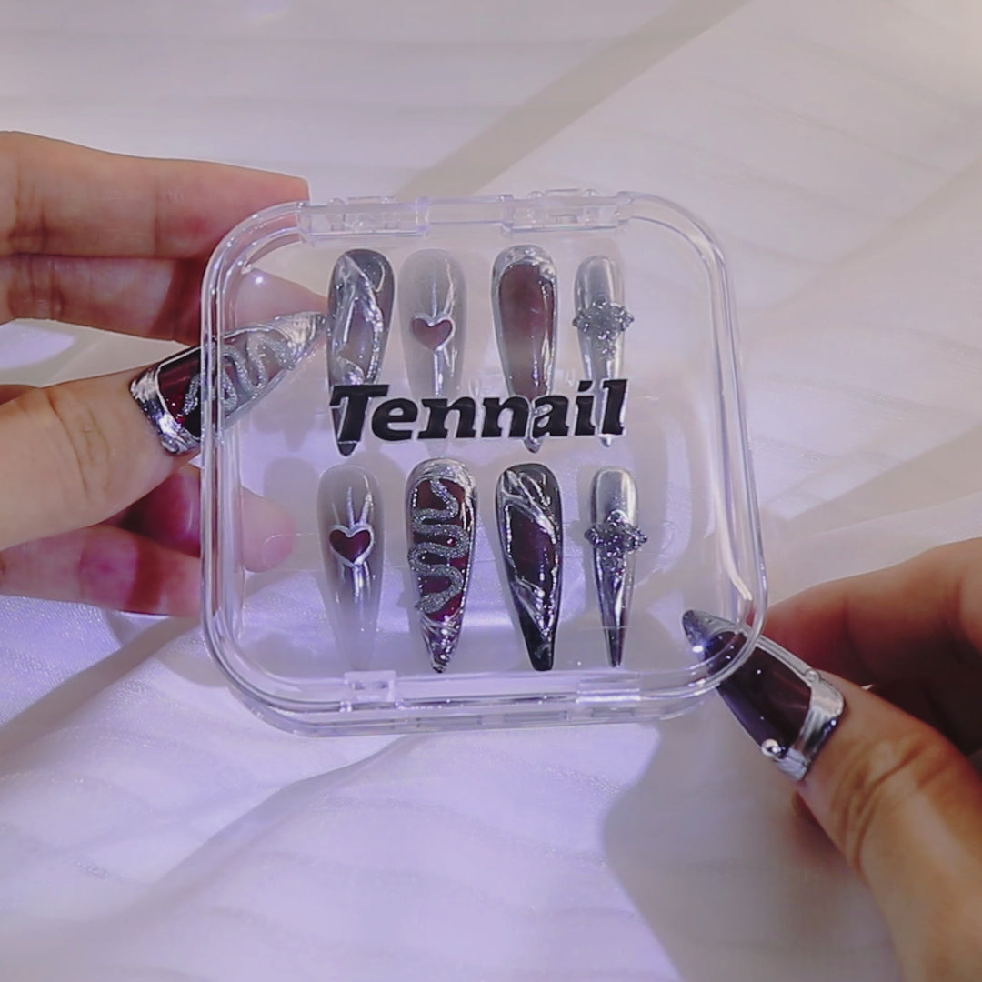 Video shows TenNail's Nocturne Serpent Nails: Handmade press - ons with red cat - eye effects and serpent elements glisten as hands move, creating a dark gothic appearance that's perfect for making a bold nail statement.