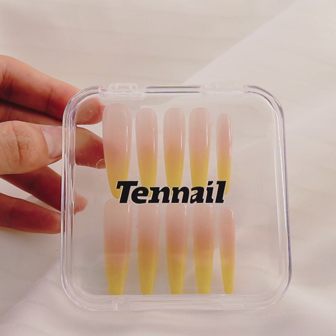 Video shows TenNail's Mango Gradient Nails: Handmade press - ons with mango - hued gradients (crafted with pat - pat glue) shimmer as hands move, offering a sweet, skin - flattering nail look.