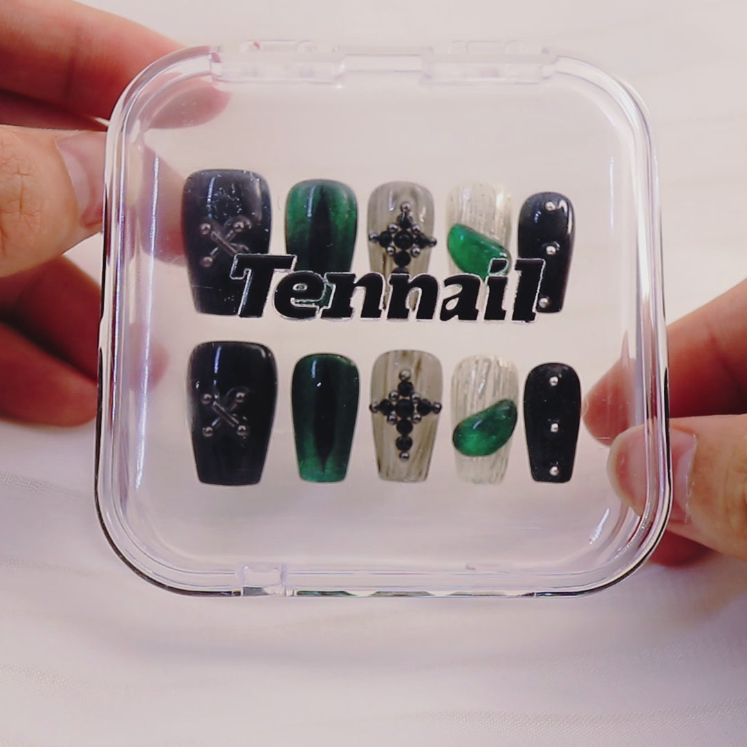 Video shows TenNail's Midnight Emerald Cross: Press - on nails with green cat - eye shimmer, medieval cross accents, and Halloween embossing catch light as hands move, crafting a luxurious and trendy Halloween - ready look.