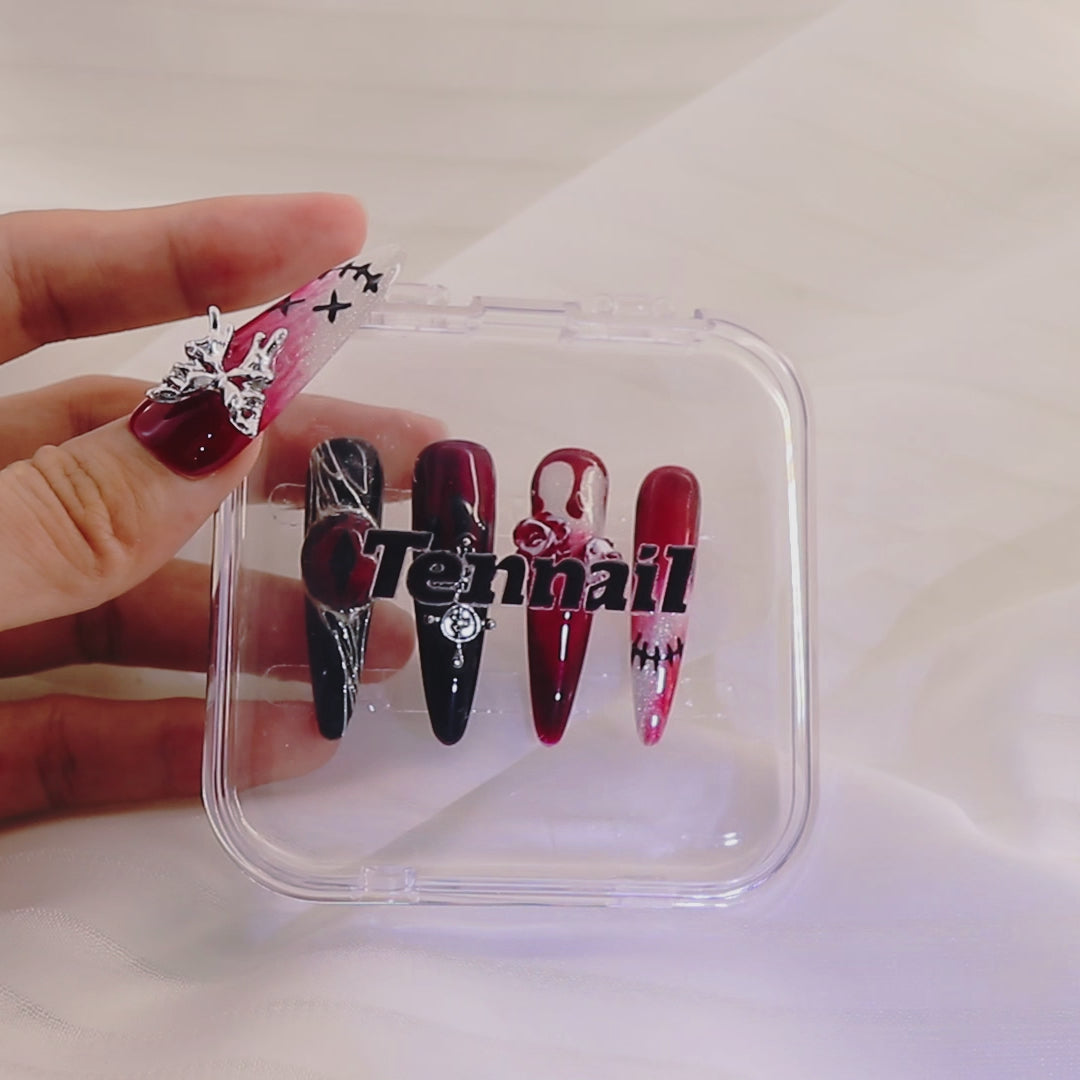 Video shows TenNail's Spooky Night Nails: Handmade press - ons with butterfly, red eye, rose elements catch light as hands move, creating a Halloween - ready look perfect for the holiday.