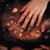 TenNail's Luna Gold Branch Nails showcase intricate gold branch details with warm, autumnal hues and floral accents, set against a mystical, smoky background for an enchanting manicure look.