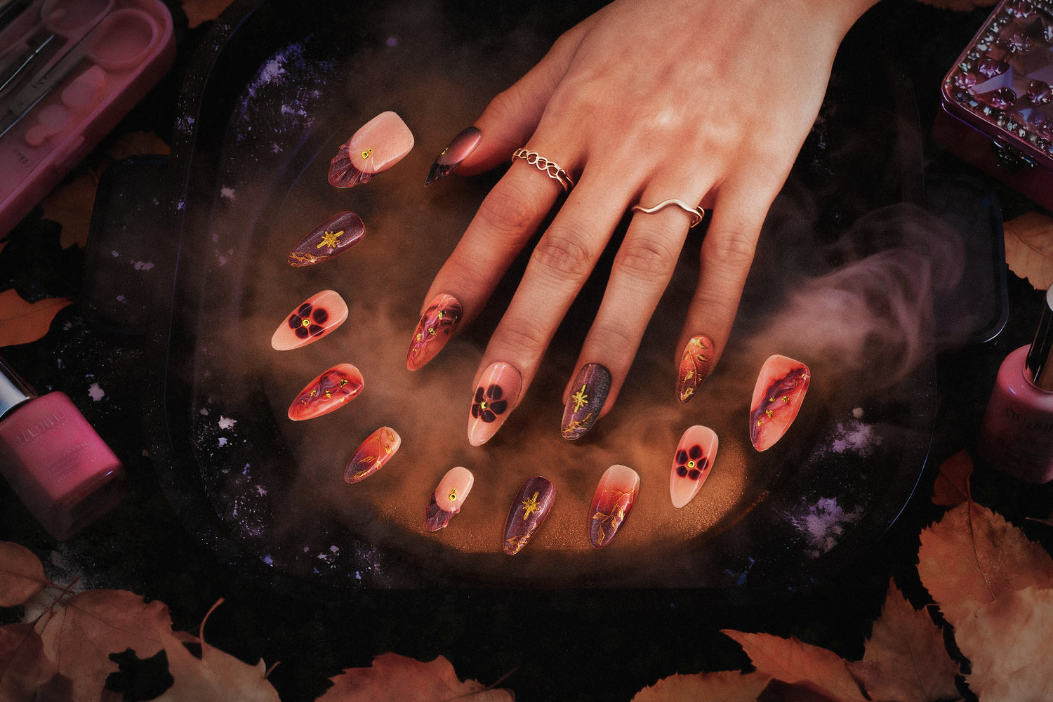 TenNail's Luna Gold Branch Nails showcase intricate gold branch details with warm, autumnal hues and floral accents, set against a mystical, smoky background for an enchanting manicure look.