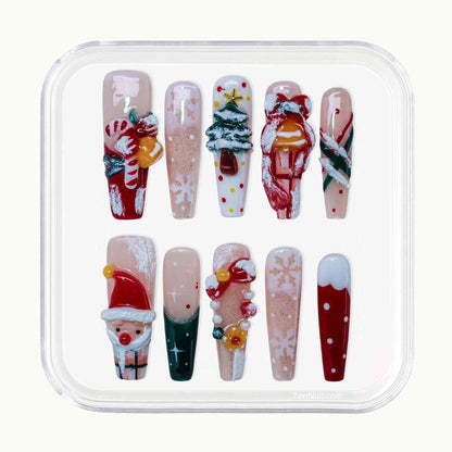 Set of Christmas-themed nail art designs in a clear plastic case. by Tennail press on nails.