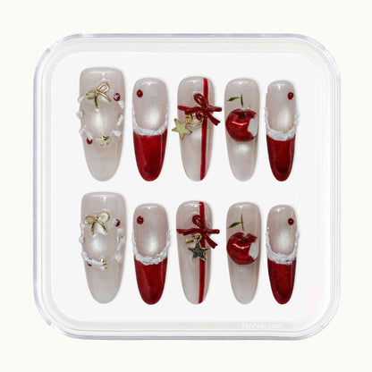 Set of Christmas-themed nail art designs in a clear plastic case.by Tennail press on nails.