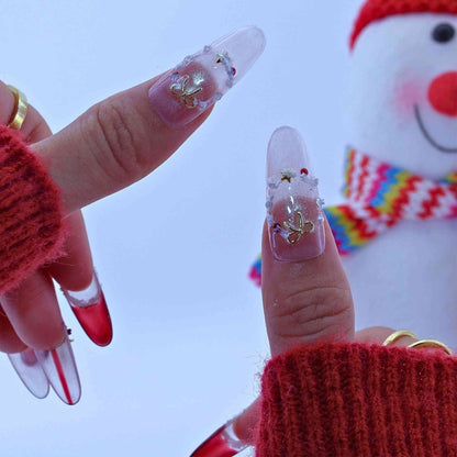 Close-up of hands with decorative nails wearing red textured sleeves against a blurred background by Tennail press on nails.