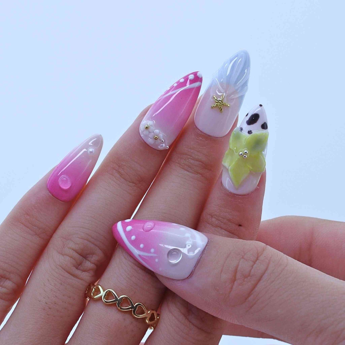 Nail art with colorful designs on a light blue background