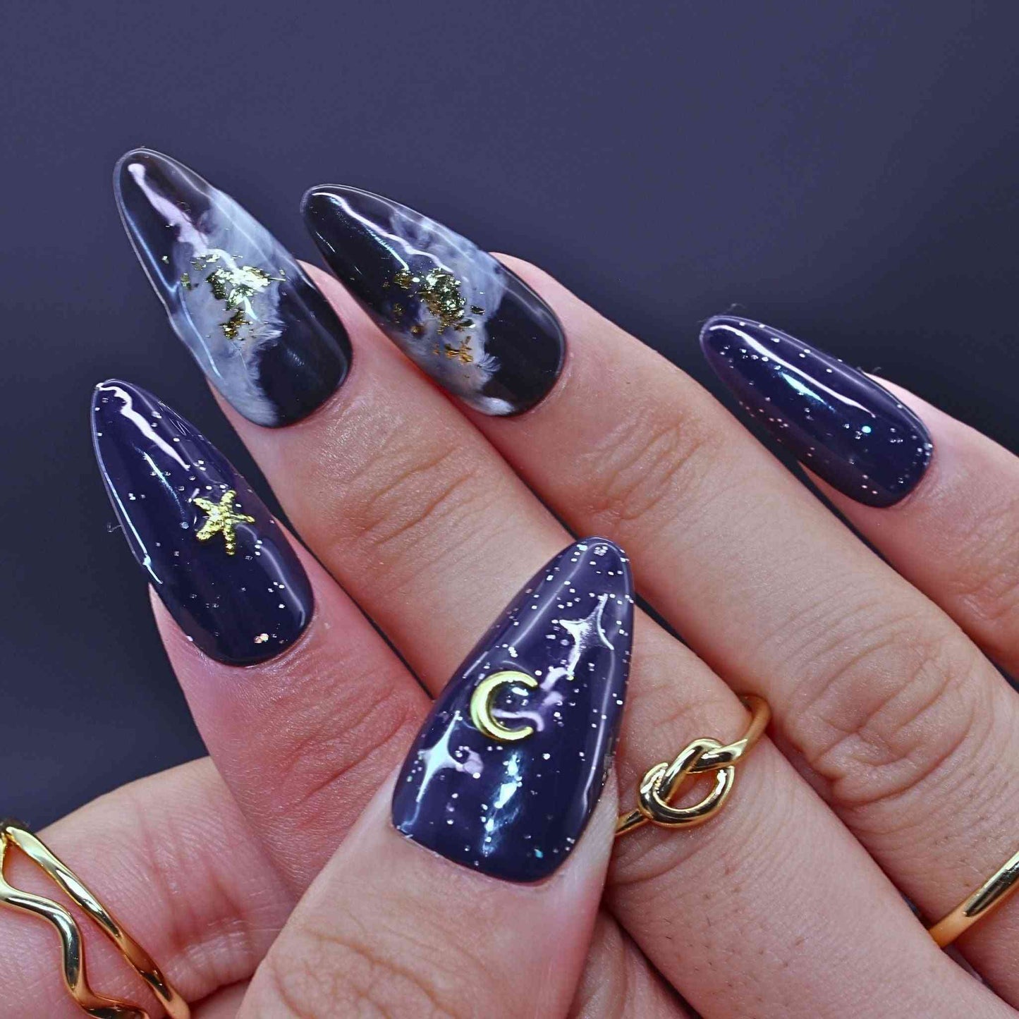 Navy blue nail polish with celestial designs by Tennail.