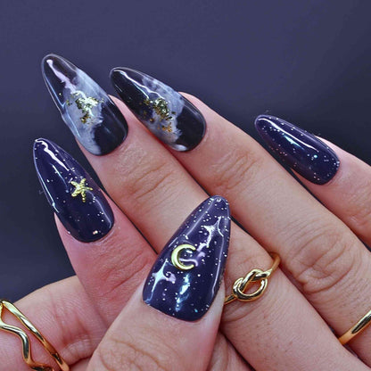 Navy blue nail polish with celestial designs by Tennail.