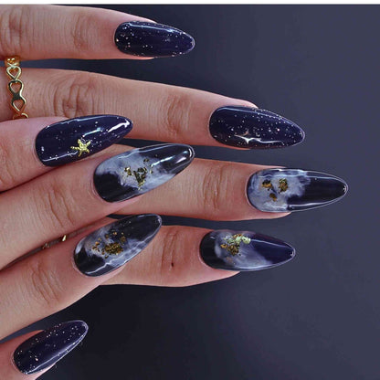 Hand with dark nail polish featuring celestial by Tennail.