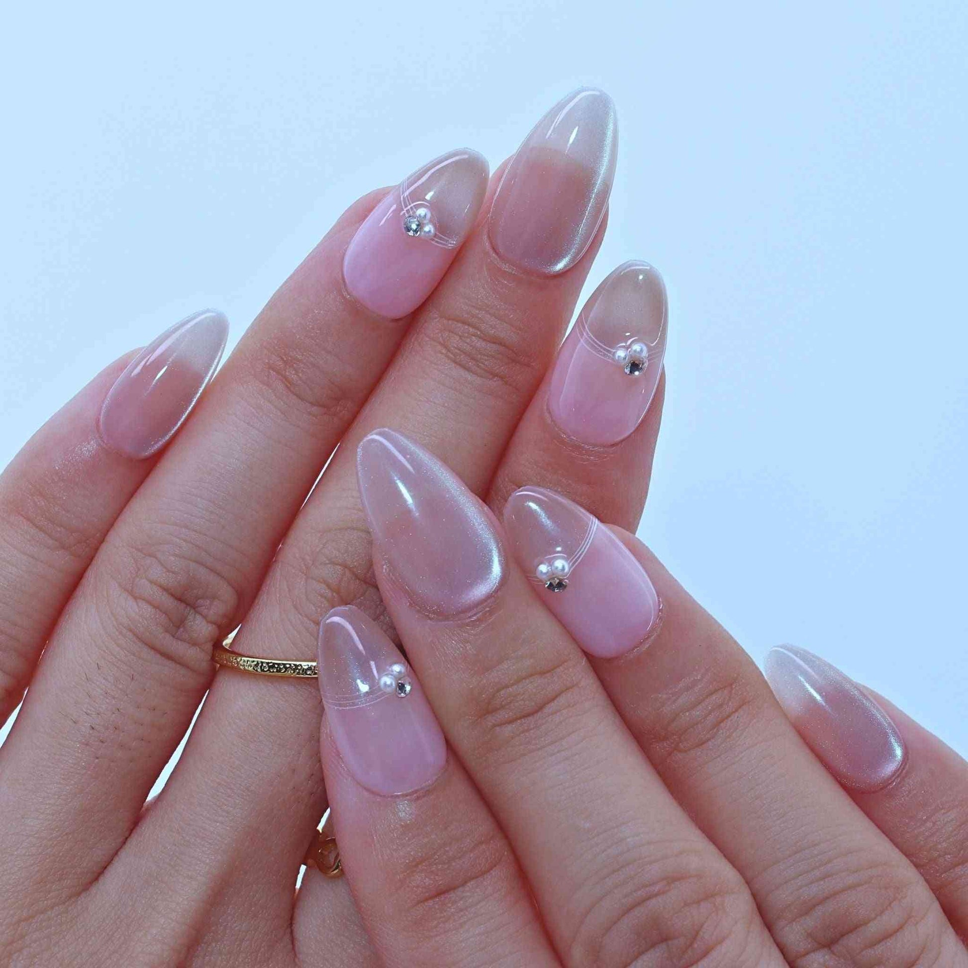 Dewy French Tip Nails with soft nude hues, French tips, rhinestone details by pressonnails