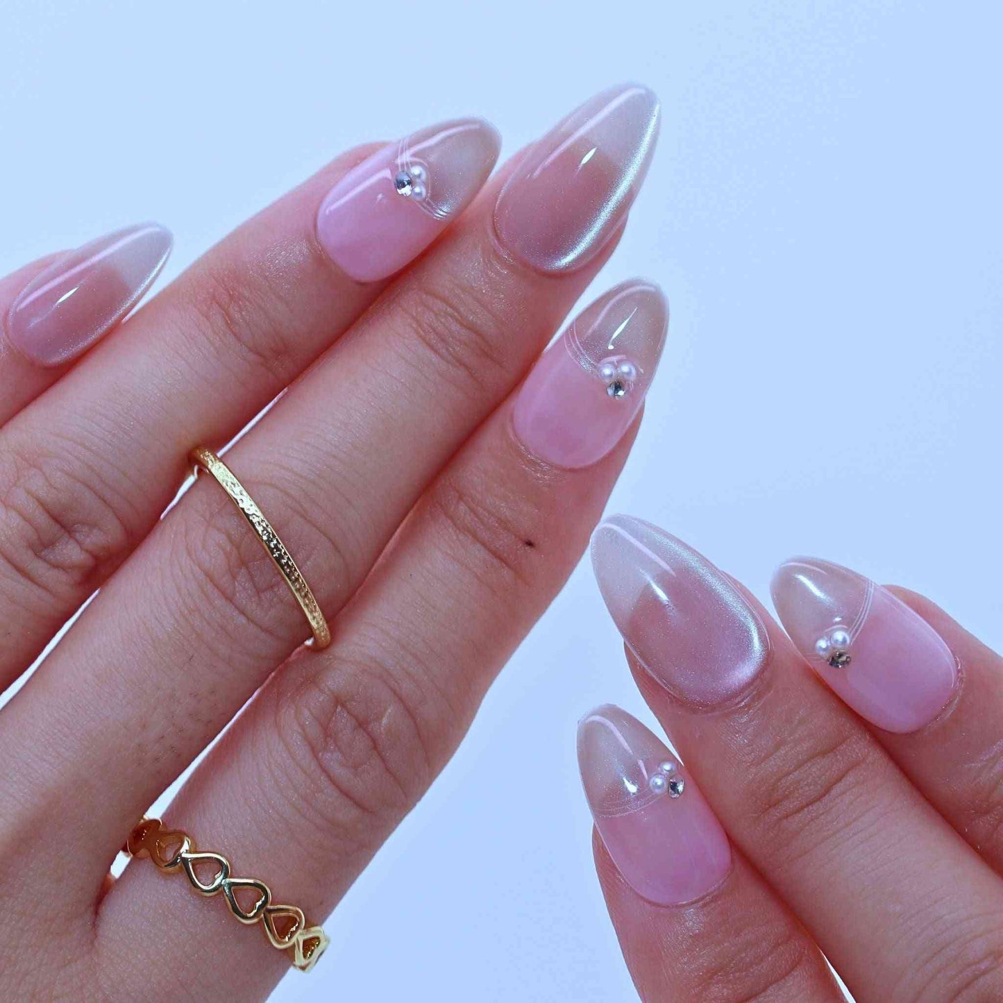 Dewy French Tip Nails with soft nude hues, French tips, rhinestone details by pressonnails