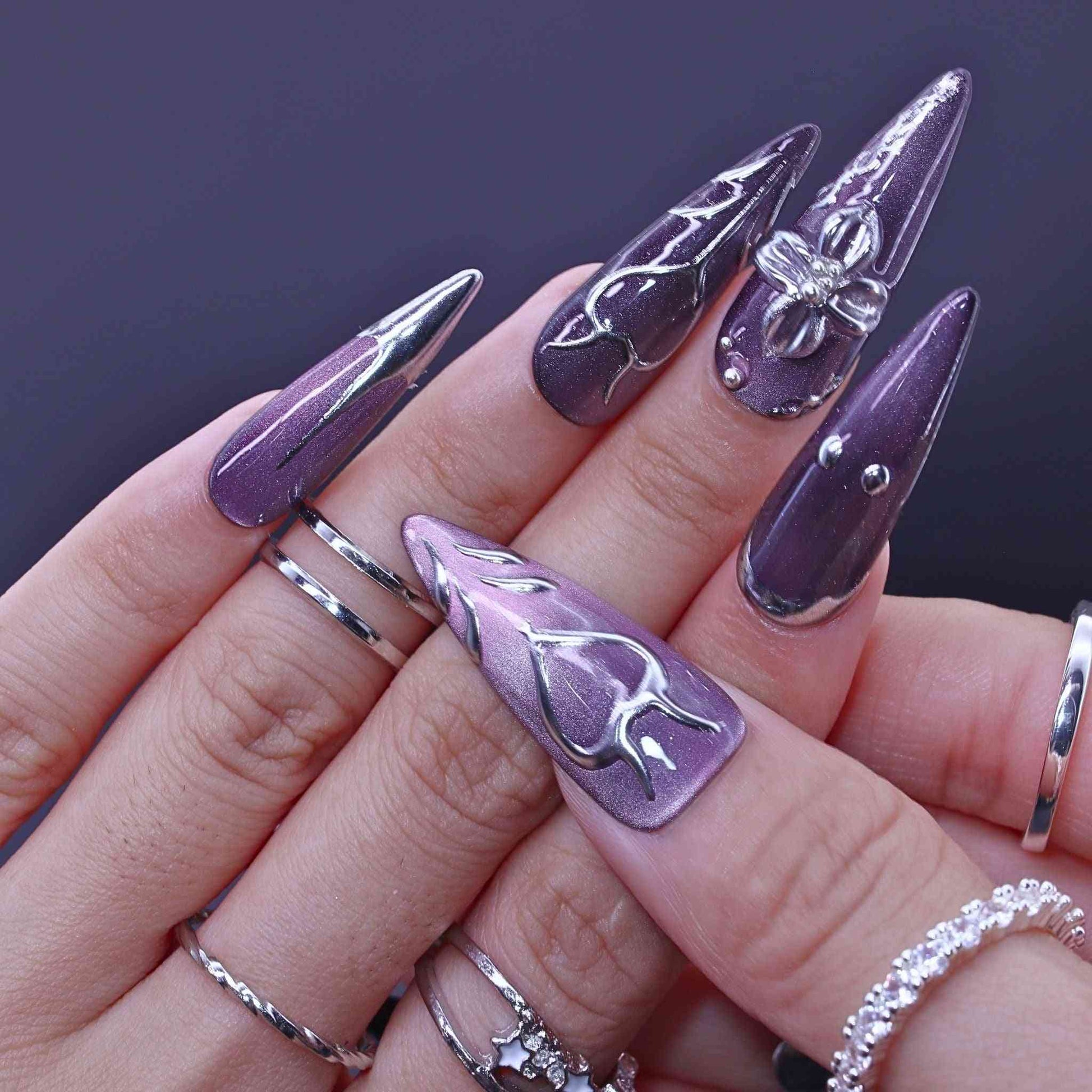 Hand with purple and silver nail art , Lavender Art press on Nails with lavender cat-eye, hand-painted florals, sleek design by Tennail