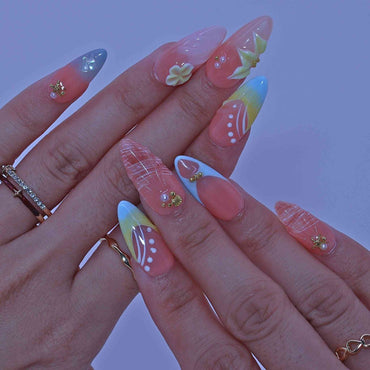 Close-up of a hand with colorful nail art , Coastal Bloom press on Nails with hand-painted florals, starfish accents, coastal hues by Tennial