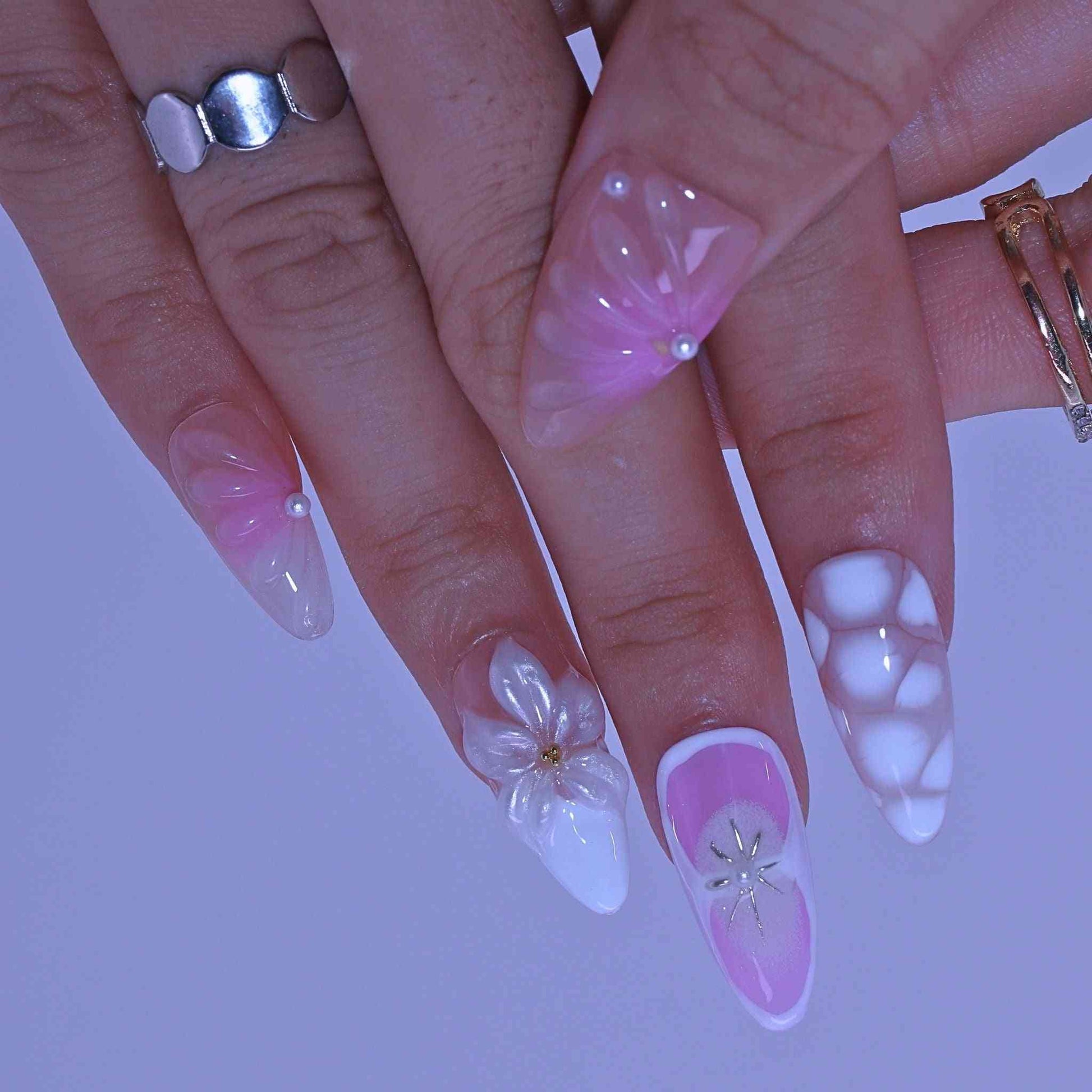 Close-up of hands with pink and white nail art, Pastel Floral press on Nails with hand-painted florals, pastel hues, delicate accents by Tennail