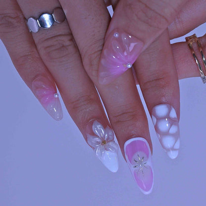 Close-up of hands with pink and white nail art, Pastel Floral press on Nails with hand-painted florals, pastel hues, delicate accents by Tennail