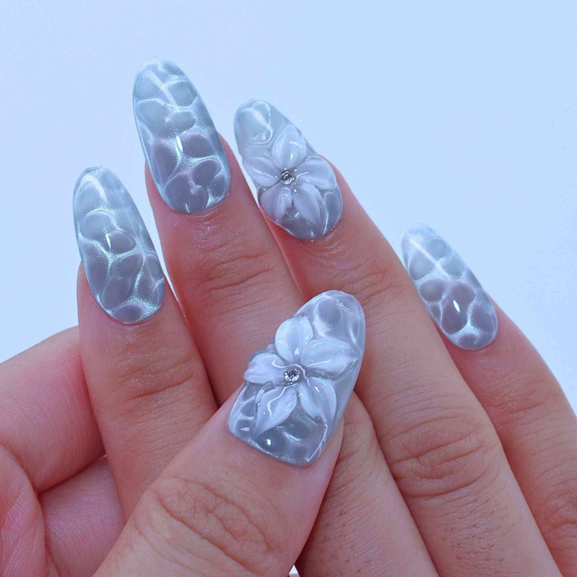 Nails with floral design and clear overlay, Aqua Wave press on Nails with hand-painted waves, aqua cat-eye, floral accents by Tennail.