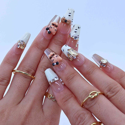Close-up of hands with decorative nails and gold rings , Kitty Leopard press on Nails with leopard print, Kitty accents, bling by Tennail.