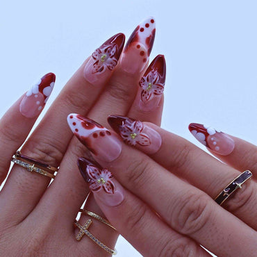 Hand with red and white floral nail art , Tropical Flowers Press on Nails with hand-painted florals, red gradients, delicate accents by Tennail.