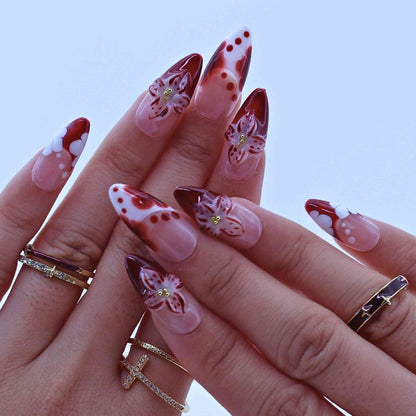 Hand with red and white floral nail art , Tropical Flowers Press on Nails with hand-painted florals, red gradients, delicate accents by Tennail.
