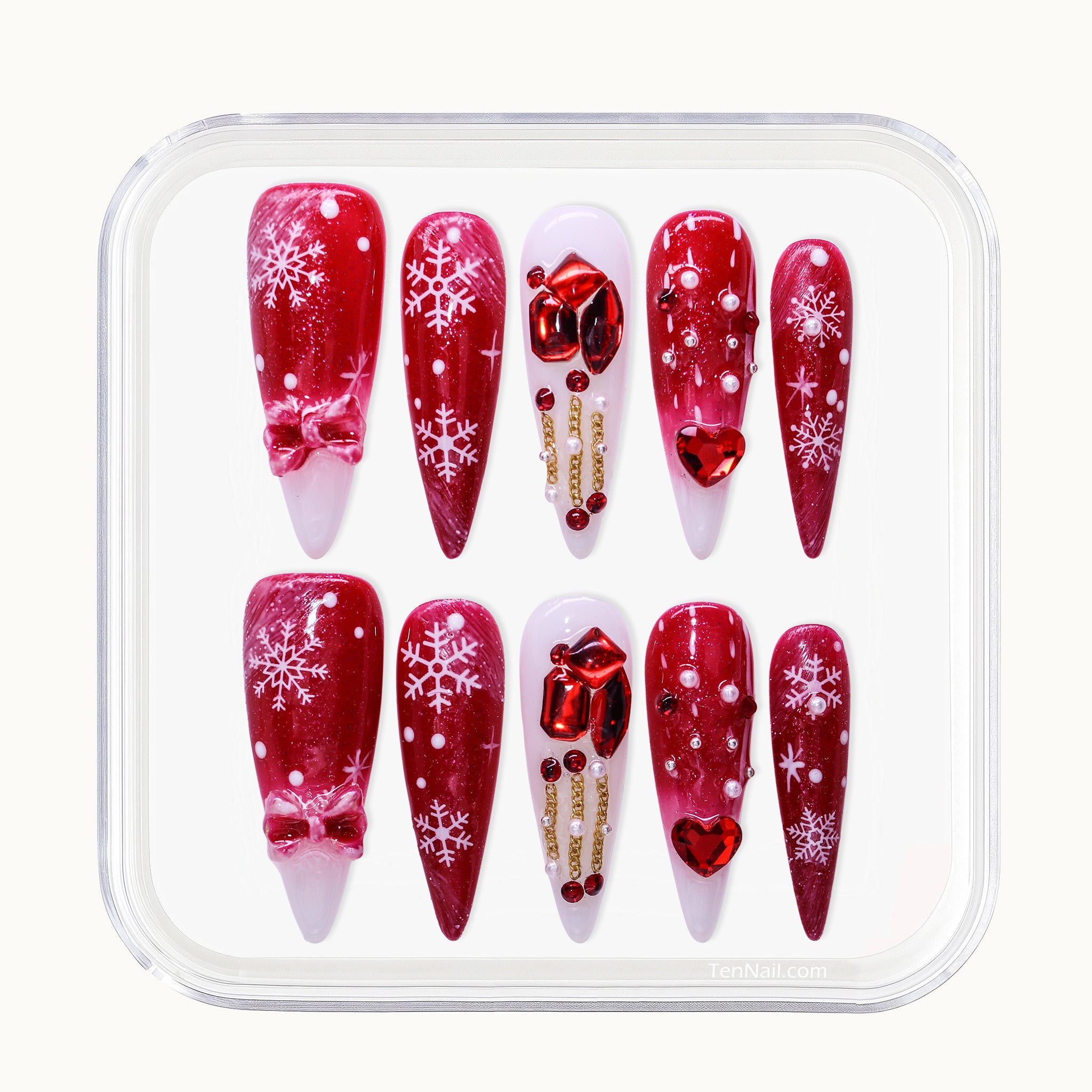 Long Stiletto Christmas press-on nails with red glitter, rhinestones, and snowflakes