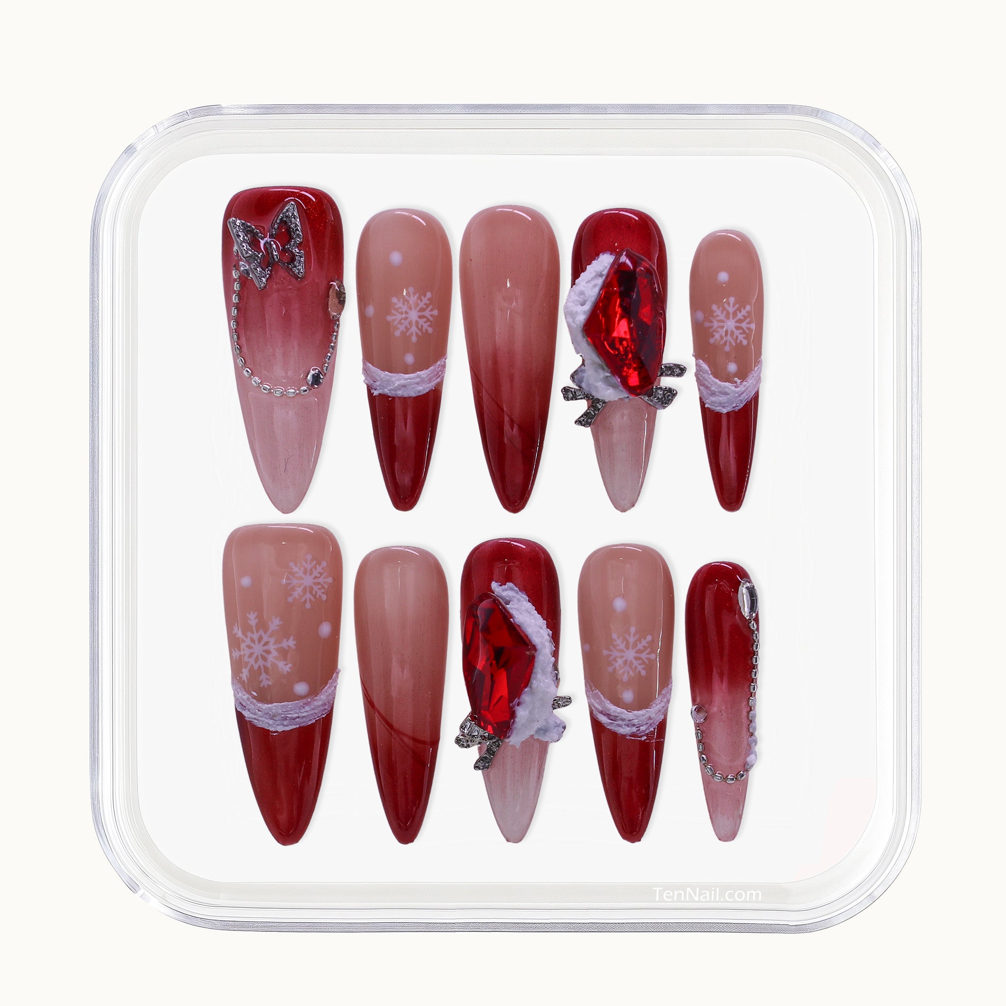 Long Stiletto Christmas press-on nails with red Ombré glitter, 3D bows, and painted snowflakes.
