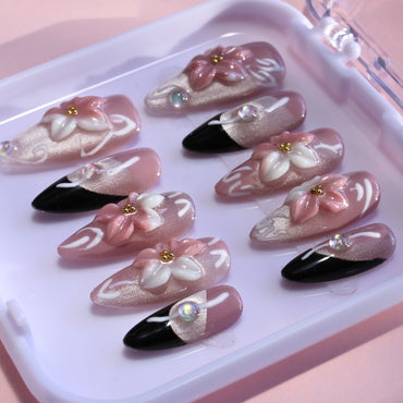 Medium Almond Tennail press-ons with pink Ombré, Cat Eye finish, and 3D floral accents.