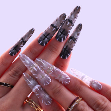 Long Stiletto Tennail press-ons in black and white Cat Eye with Gothic cross religious symbols.