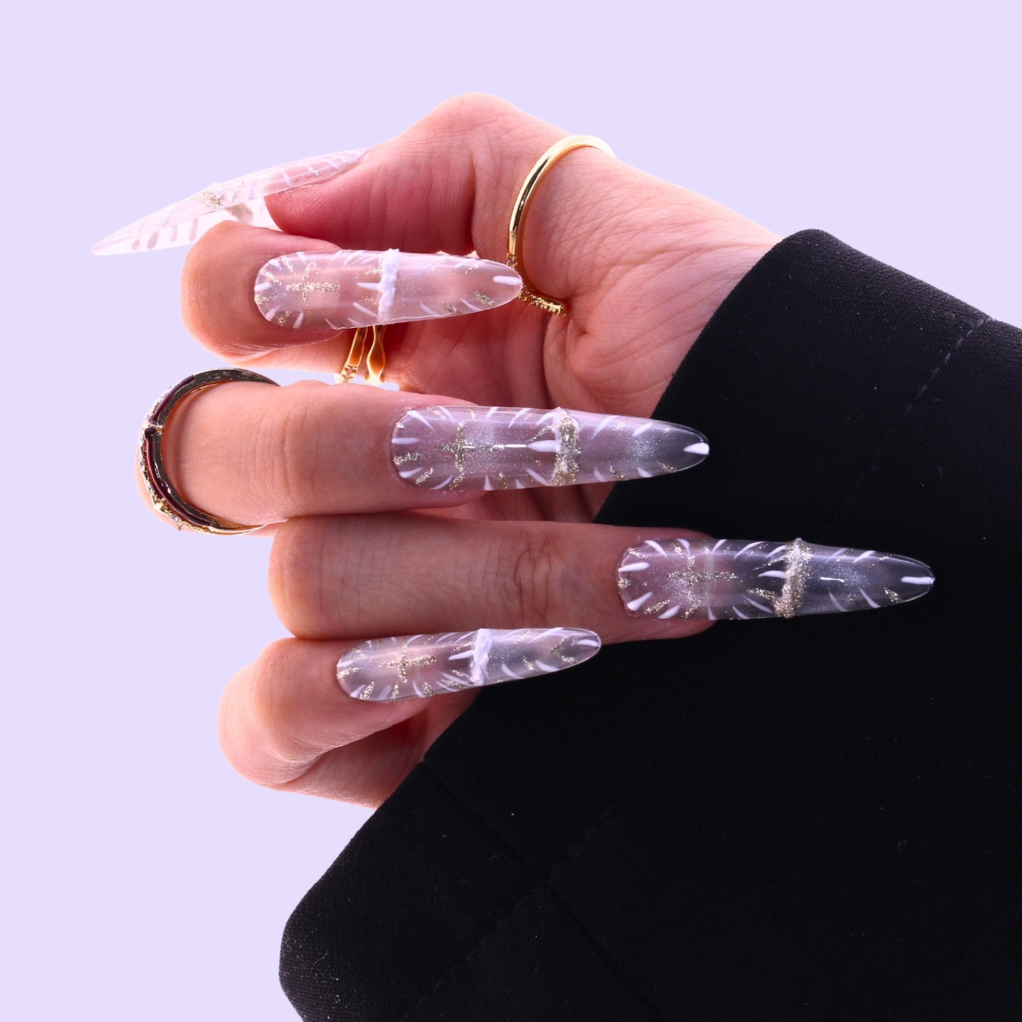 Hand wearing clear nail extensions with a gold ring, Tennail handmade press on nails.