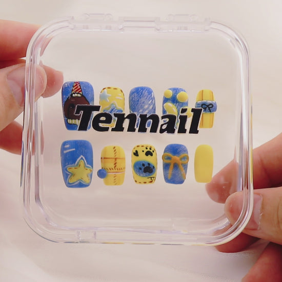 Video shows TenNail's Whimsy Pup Nails: Press - on nails with adorable puppy illustrations, star details, and a vibrant blue - yellow color combo catch the light as hands move. This creates a fun, cheerful style that exudes joy and playfulness, making them a charming addition to any outfit.