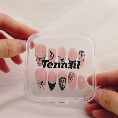 Video shows TenNail's Spooky Pink Nails: Press - on nails with pink bases, black skulls, and spider webs catch the light as hands move, creating a cute and spooky Halloween atmosphere that's perfect for celebrating the holiday.