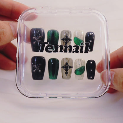 Video shows TenNail's Midnight Emerald Cross: Press - on nails with green cat - eye shimmer, medieval cross accents, and Halloween embossing catch light as hands move, crafting a luxurious and trendy Halloween - ready look.